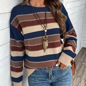 Color blocked striped crew neck long sleeve women’s sweater. Blue, brown, tan.